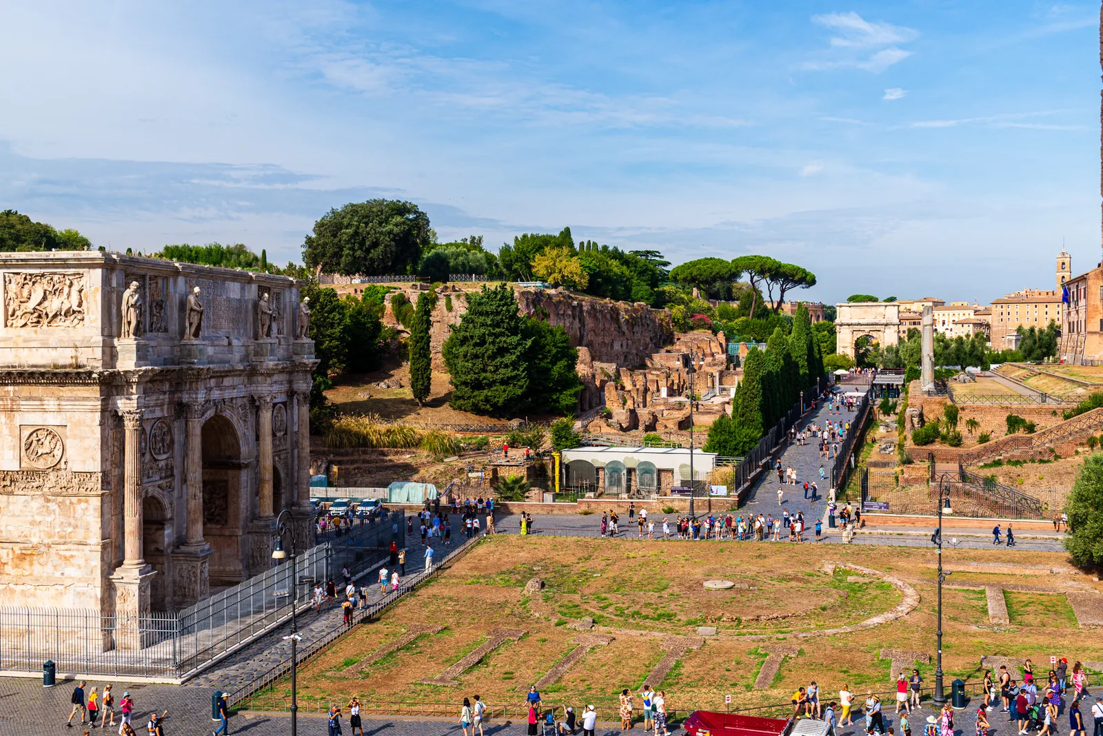 The historic Arch of Constantine standing near the edge of the Roman Forum grounds
