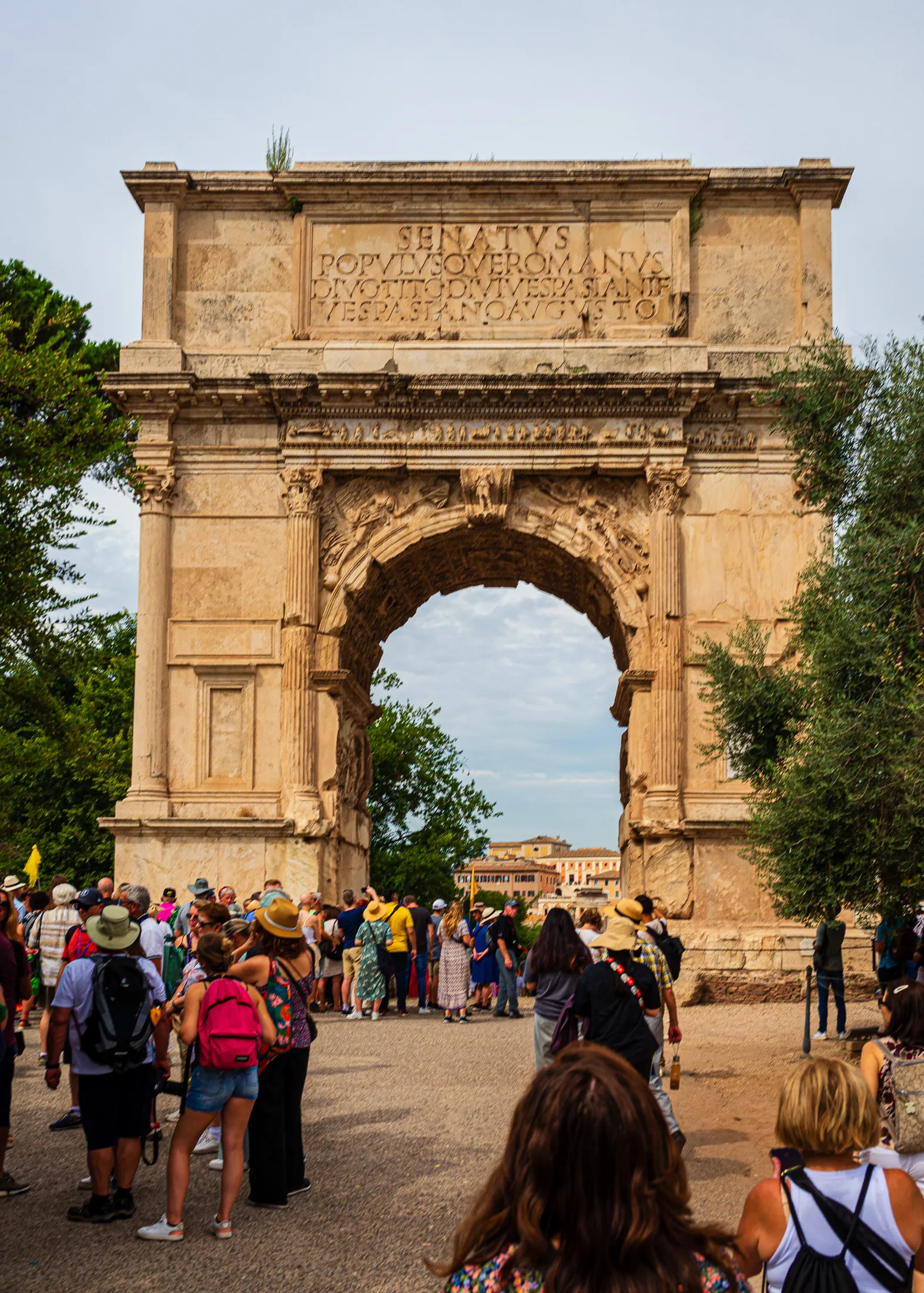 A clean full view framing the architectural structure of the historic Arch of Titus