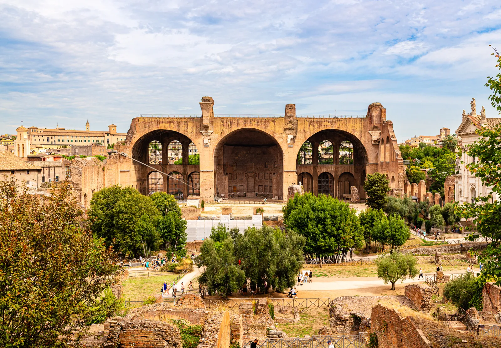 Wide structural view looking up at the monumental stone remains of the Basilica of Maxentius and Constantine