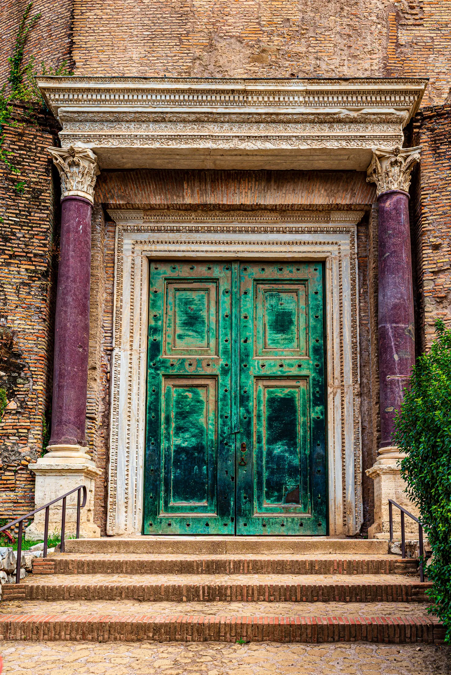 The massive, green-patina ancient bronze doors of the Temple of Romulus