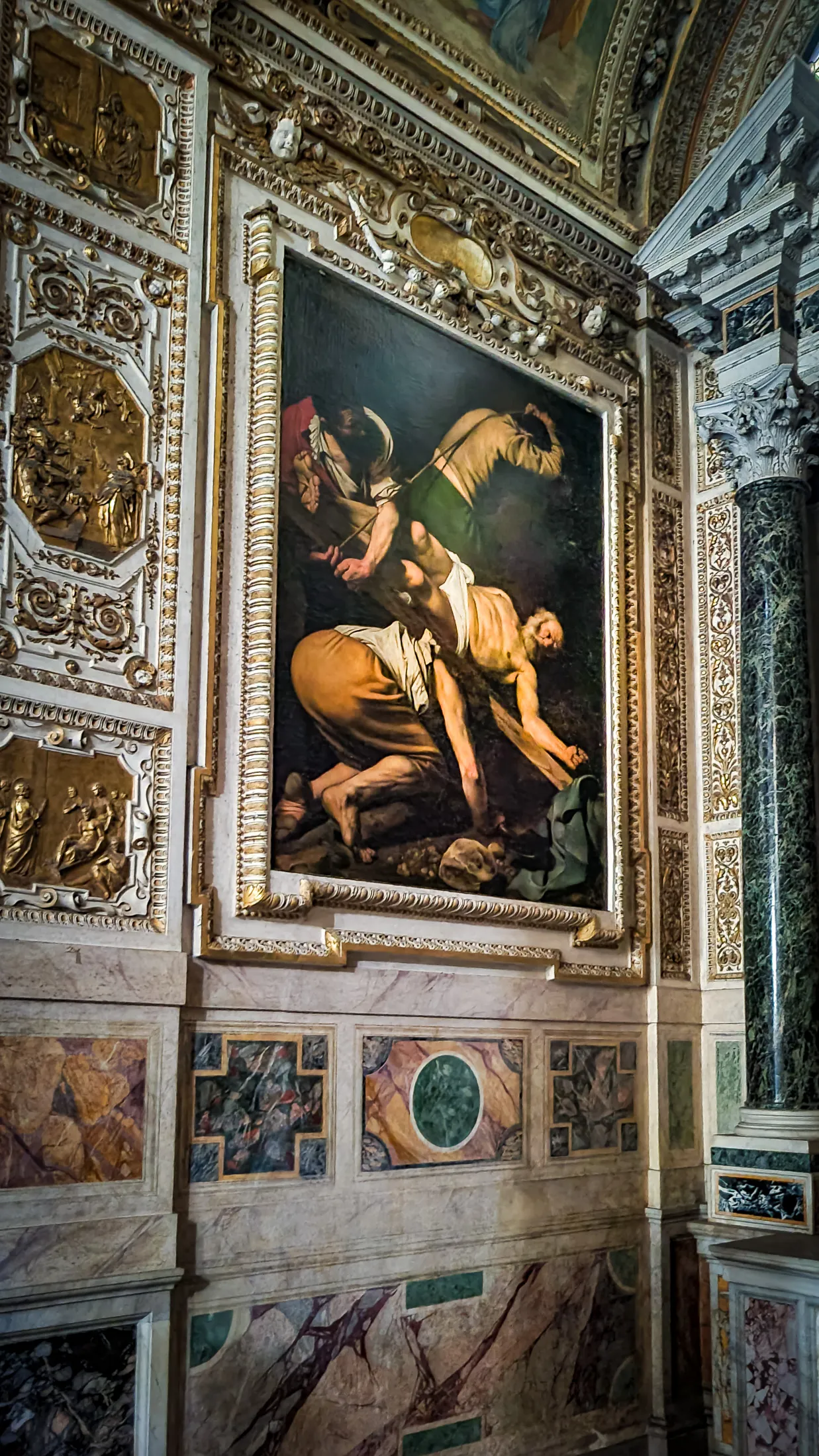 The dramatic baroque lighting of Caravaggio The Crucifixion of Saint Peter painting