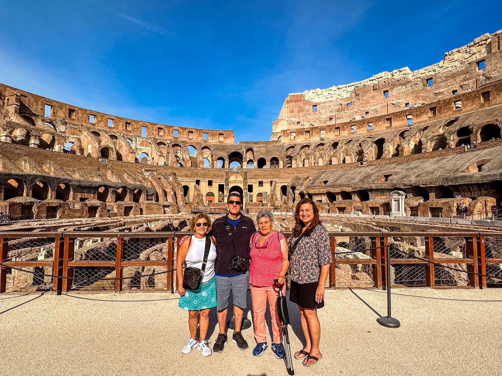 Family group portrait posing inside the sweeping stone arches of the Colosseum
