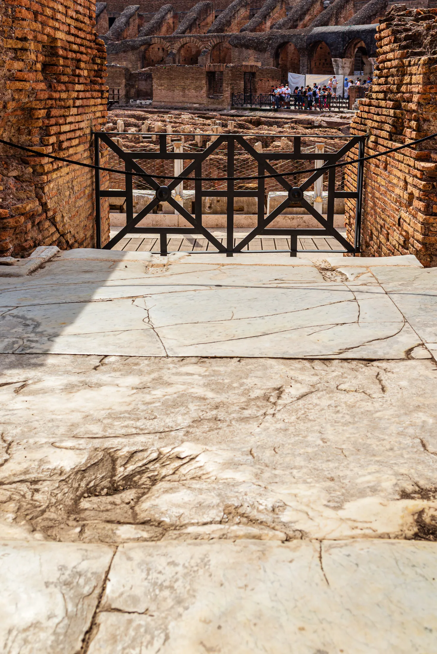 Detailed close-up of the historical marble floor elements inside the Colosseum