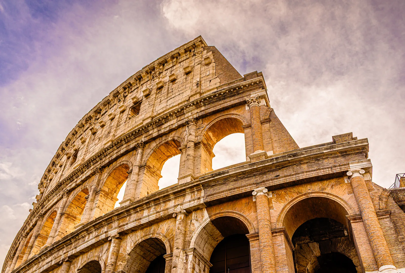 The dramatic ancient stone exterior walls of the Colosseum