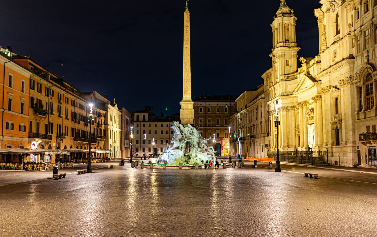 Piazza Navona at night, illuminated by warm lighting