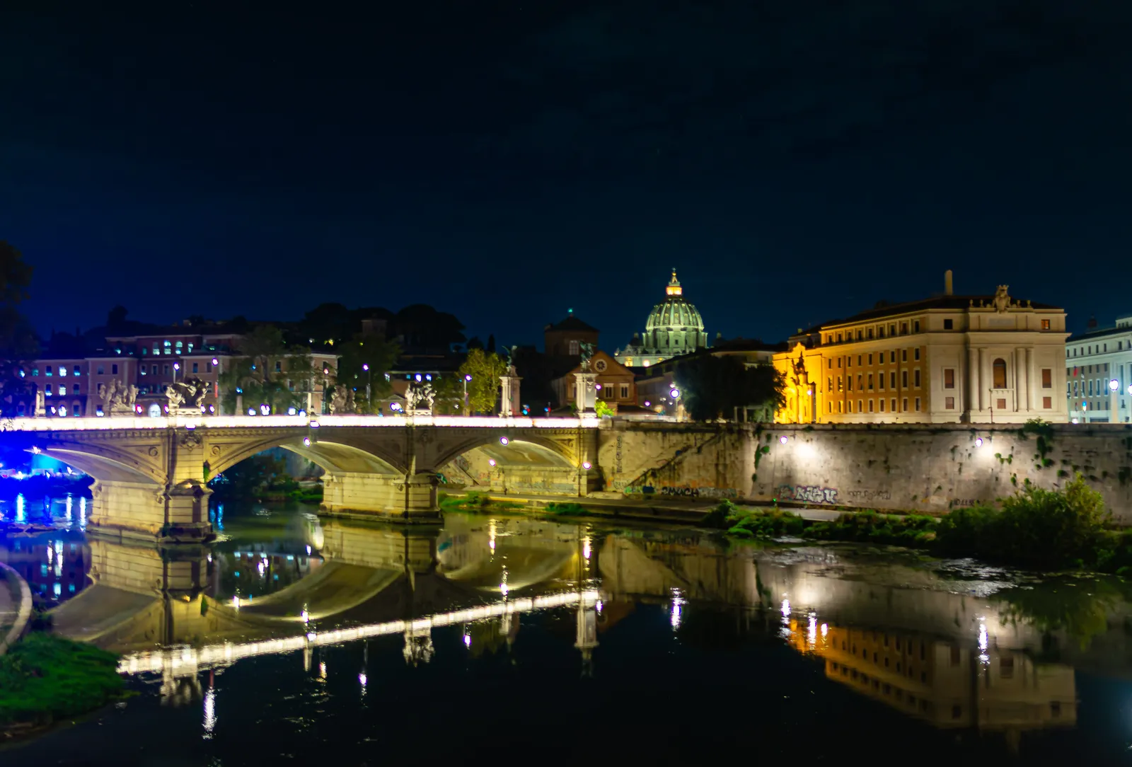 Ponte Vittorio Emanuele II bridge at night, with the illuminated Castel Sant Angelo in the background